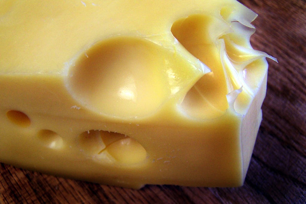 Why Does Swiss Cheese Have Holes? Science Figured It Out — And Also Why